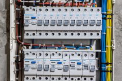 Voltage switchboard with circuit breakers are in the ON and OF positions in the big electric box for electrical distribution panel, and temporary electric cables are switched.